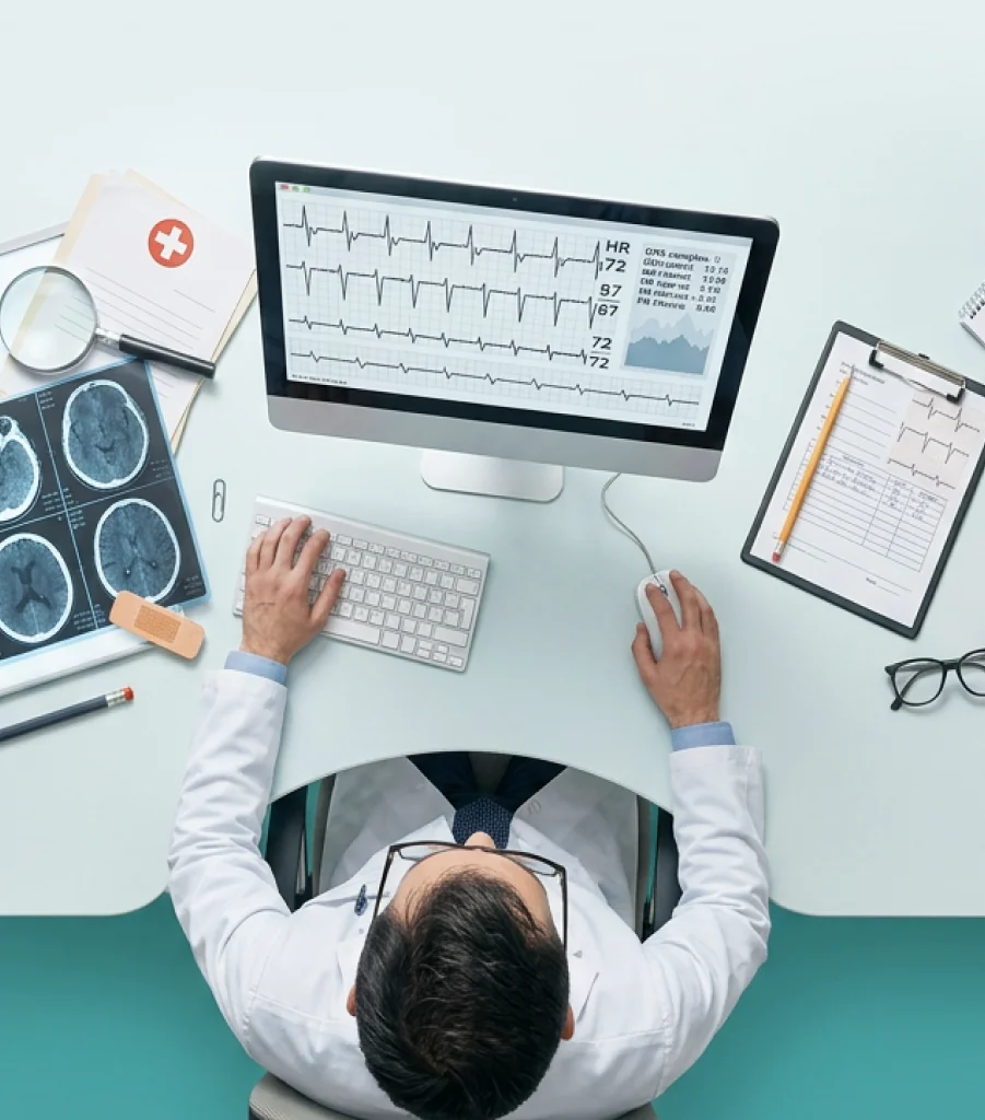 A clinician reviewing heart failure data at a desk