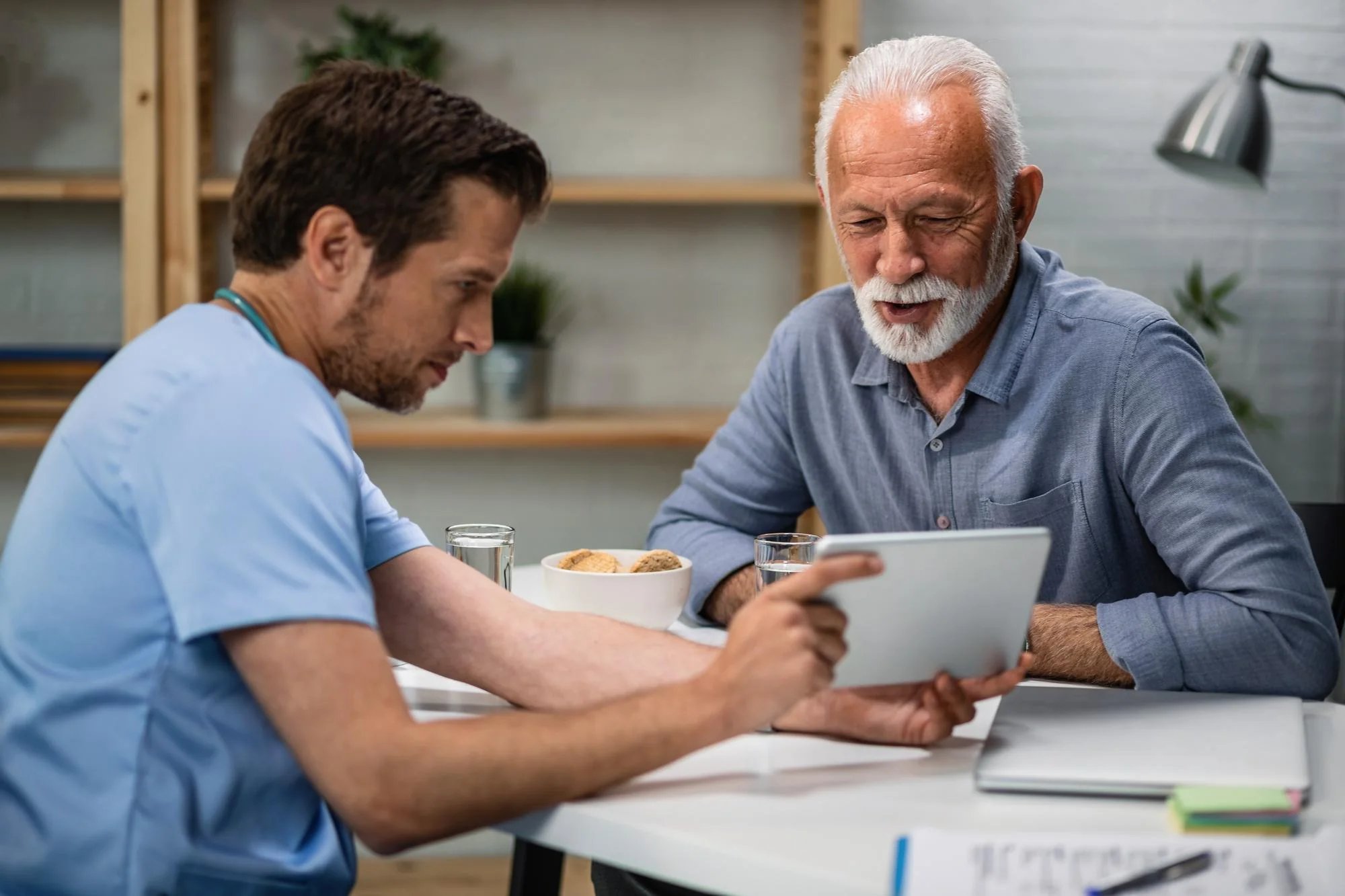 A clinician reviewing results on a tablet with a patient